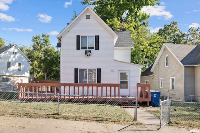 view of front facade featuring a deck and a front lawn