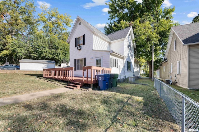 rear view of property with central AC, a yard, and a deck