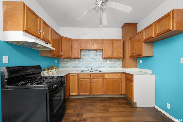 kitchen featuring gas stove, decorative backsplash, ceiling fan, dark hardwood / wood-style floors, and sink