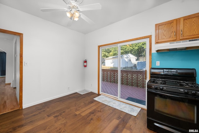 kitchen with ceiling fan, black gas range oven, and dark hardwood / wood-style flooring