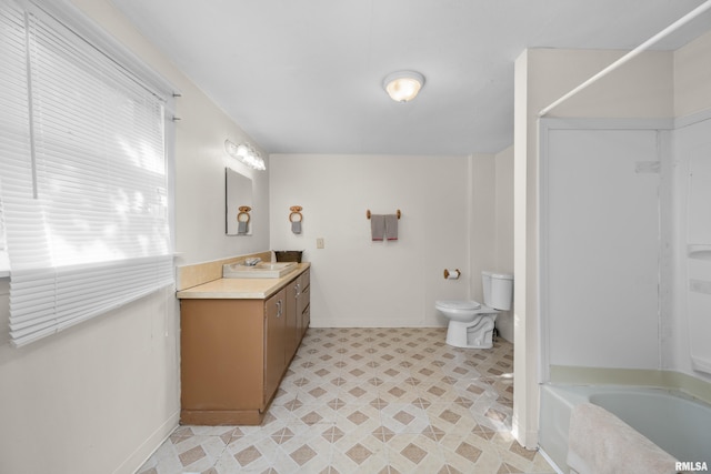 bathroom featuring vanity, a bathtub, and toilet