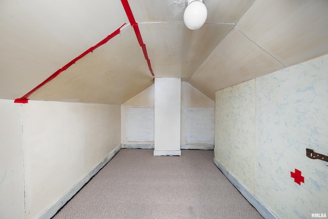 bonus room featuring lofted ceiling and carpet flooring