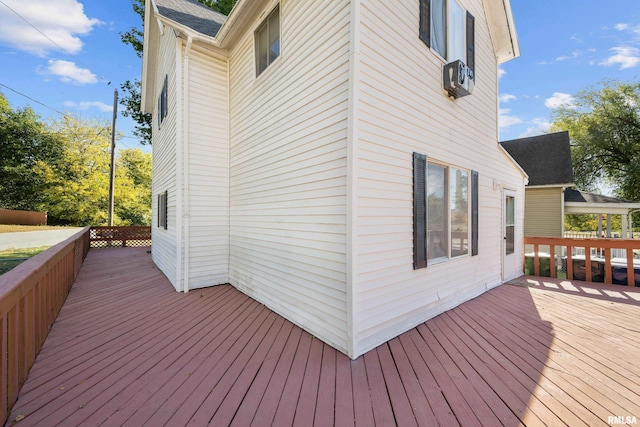 wooden deck featuring cooling unit