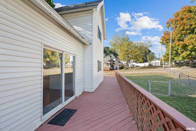 wooden terrace featuring a yard