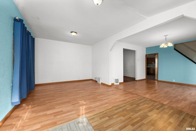 interior space featuring hardwood / wood-style flooring and an inviting chandelier