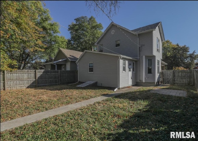 back of property featuring a yard