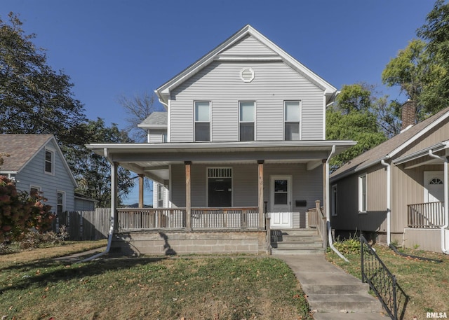 farmhouse with covered porch and a front yard