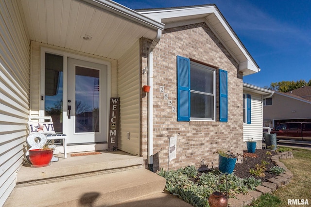 view of exterior entry with covered porch