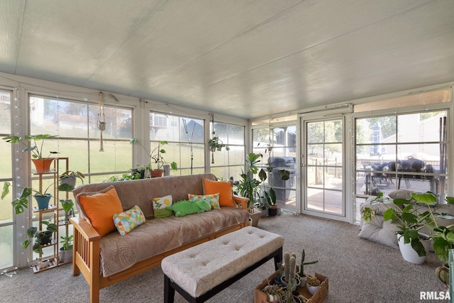 sunroom featuring plenty of natural light and lofted ceiling