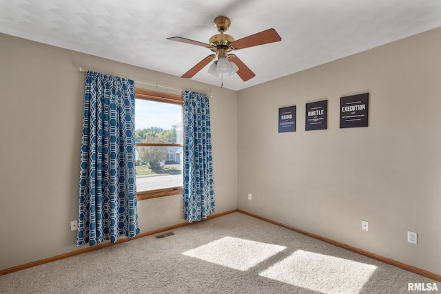 empty room featuring carpet floors and ceiling fan