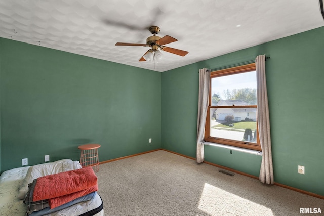 interior space featuring ceiling fan and carpet floors