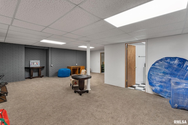 interior space with a drop ceiling and carpet flooring