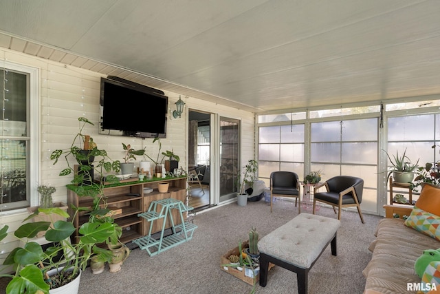 living room with carpet and wooden walls