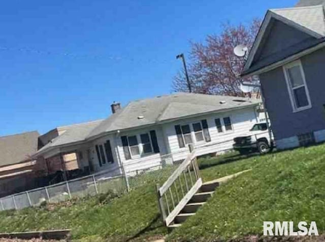 rear view of house with a yard