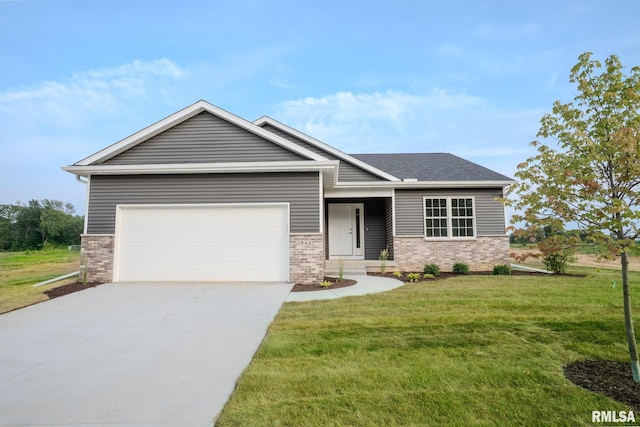 941 9th Ave N, Clinton, IA 52732 - view of front of house featuring brick siding, a front yard, concrete driveway, and an attached garage