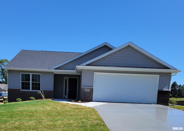 view of front of house with a front yard and a garage