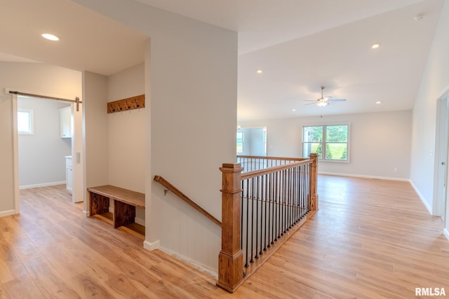 941 9th Ave N, Clinton, IA 52732 - hall featuring light wood finished floors, an upstairs landing, a barn door, and recessed lighting