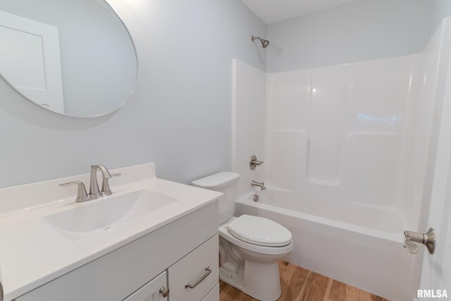 941 9th Ave N, Clinton, IA 52732 - bathroom with vanity, wood finished floors, and shower / bathtub combination