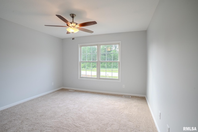 941 9th Ave N, Clinton, IA 52732 - carpeted spare room featuring baseboards and a ceiling fan