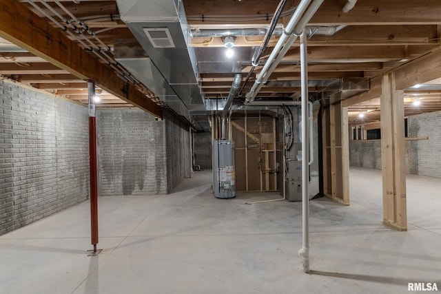 941 9th Ave N, Clinton, IA 52732 - unfinished basement featuring water heater, brick wall, and heating unit