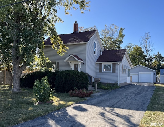 view of side of home featuring an outbuilding, a garage, and a lawn