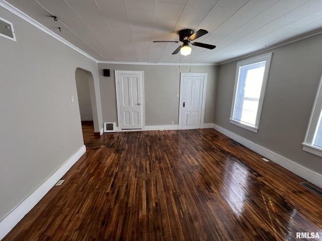 spare room with dark wood-type flooring, ceiling fan, and crown molding