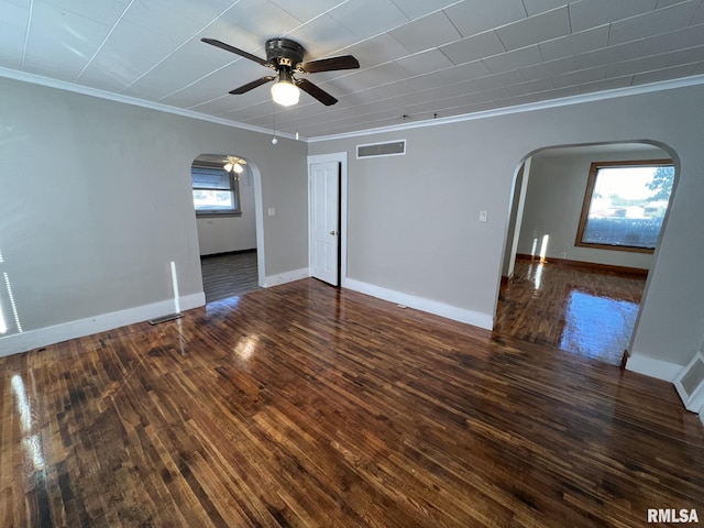 empty room featuring ceiling fan, dark hardwood / wood-style floors, and crown molding