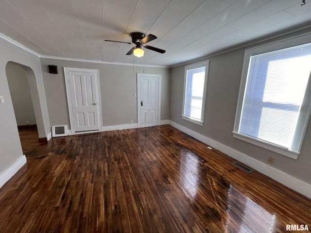 spare room with dark hardwood / wood-style flooring, ceiling fan, and crown molding