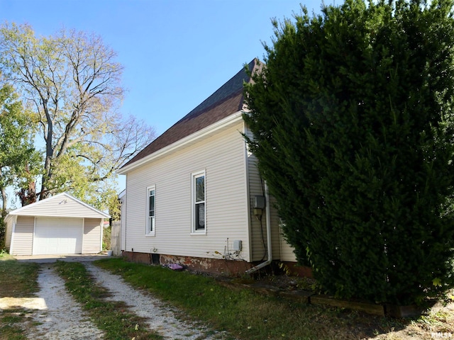 view of home's exterior featuring an outbuilding and a garage