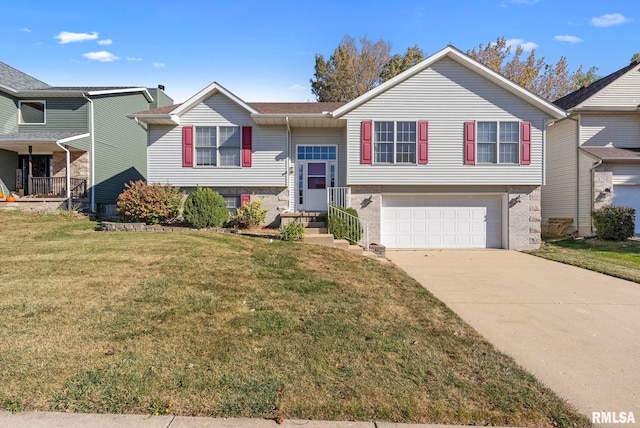 split foyer home featuring a garage and a front yard