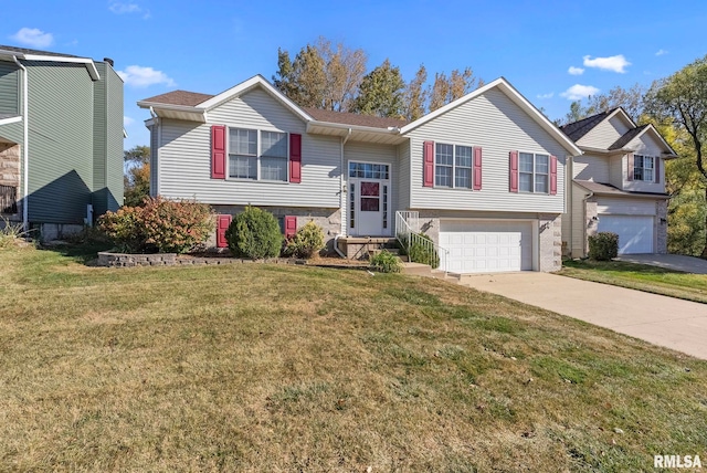 raised ranch featuring a garage and a front yard