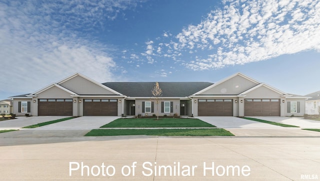 view of front of home featuring concrete driveway, an attached garage, and a front yard