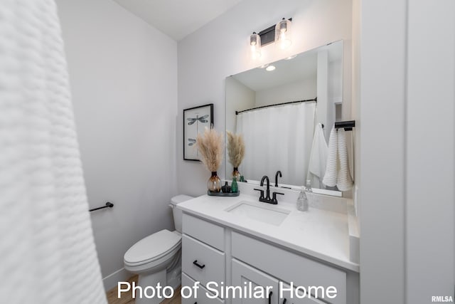 bathroom featuring vanity and toilet