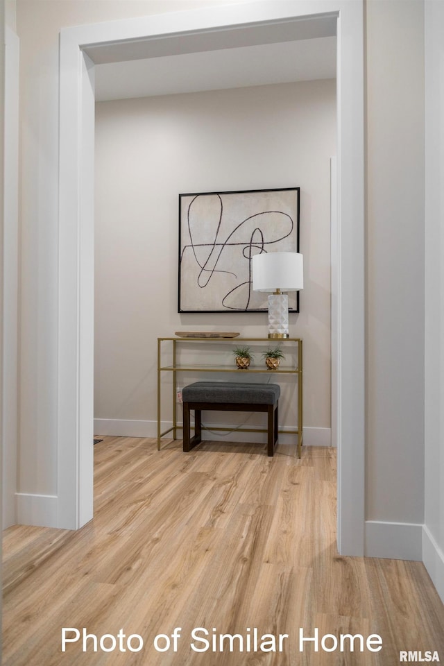 hall with hardwood / wood-style floors