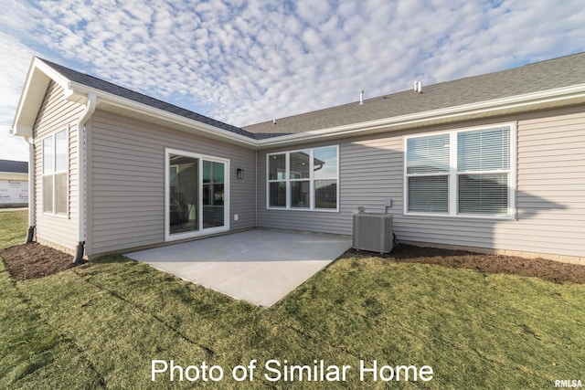 back of house with a patio, central AC unit, and a lawn