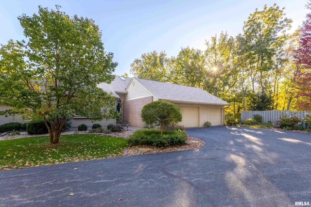 view of side of home featuring a yard and a garage