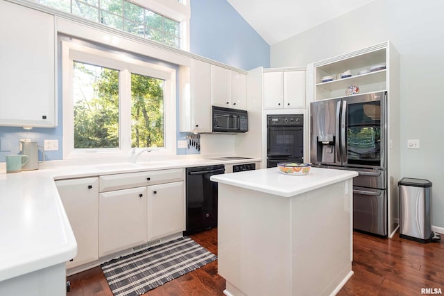 kitchen featuring black appliances, white cabinets, and dark wood-type flooring