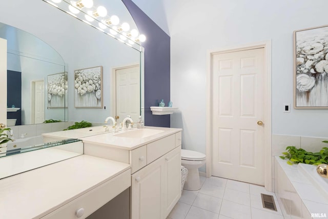 bathroom with vanity, vaulted ceiling, toilet, and tile patterned flooring