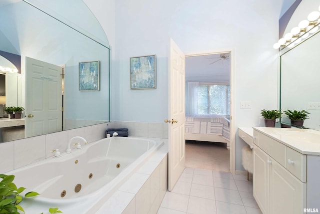 bathroom with tiled bath, ceiling fan, tile patterned floors, a high ceiling, and vanity