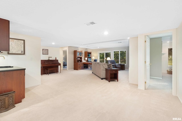 carpeted living room featuring sink