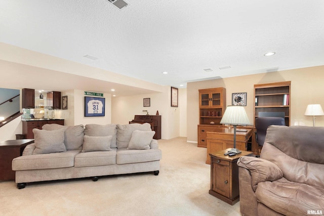 living room featuring light carpet and a textured ceiling