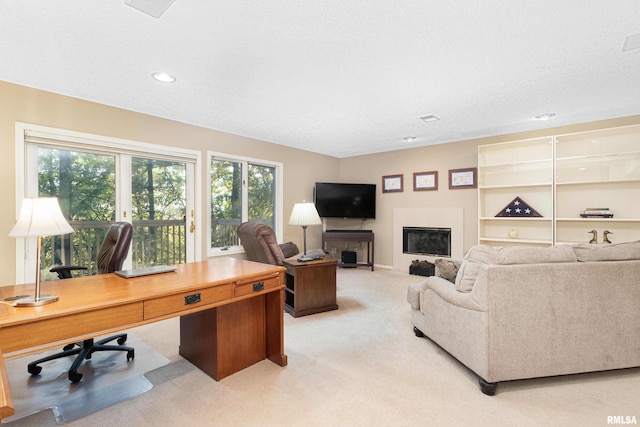 carpeted living room featuring a textured ceiling