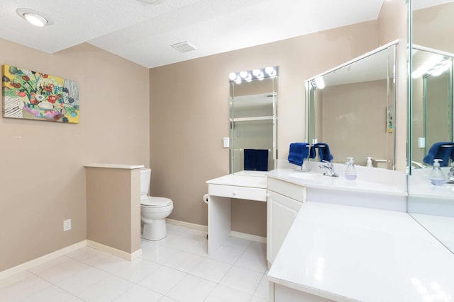 bathroom featuring vanity, a textured ceiling, toilet, and walk in shower