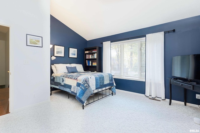 bedroom featuring vaulted ceiling and carpet floors