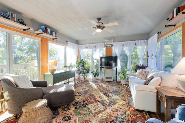 sunroom / solarium featuring ceiling fan and a wall mounted air conditioner