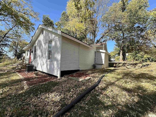view of side of home with central AC unit