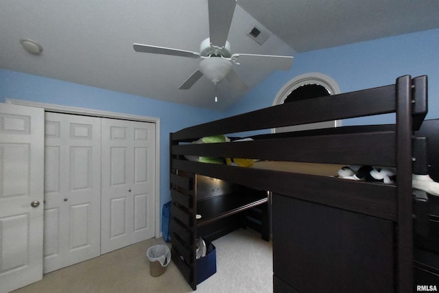 carpeted bedroom featuring a closet, ceiling fan, and lofted ceiling