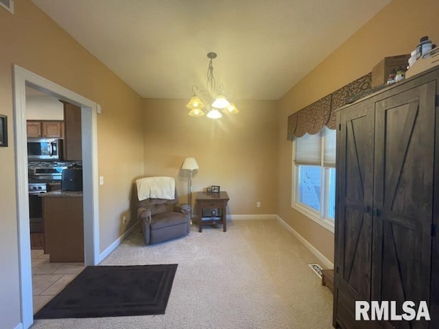 sitting room featuring light carpet and a chandelier