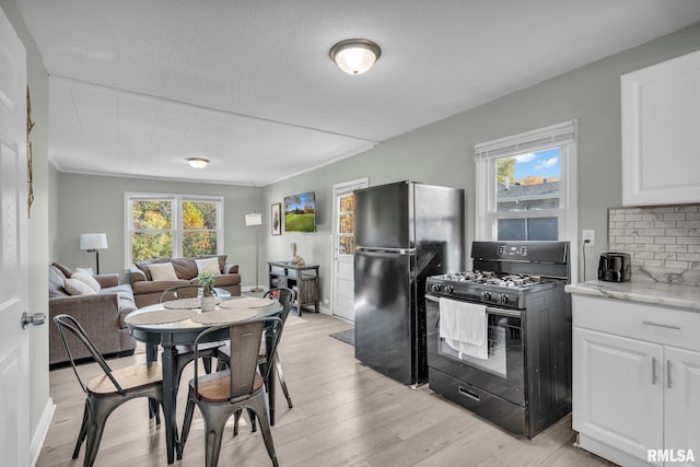 906 28 1/2 St, Bettendorf, IA 52722 - dining space with light wood-style floors