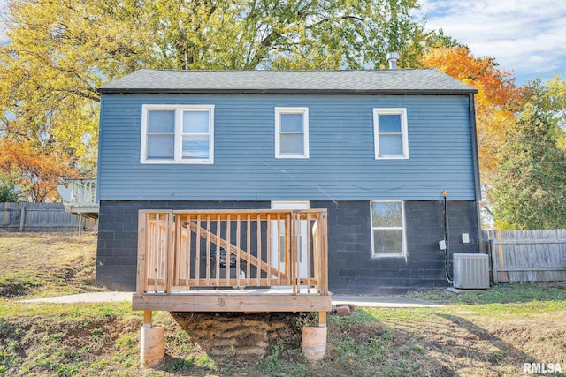 rear view of property featuring cooling unit and a deck